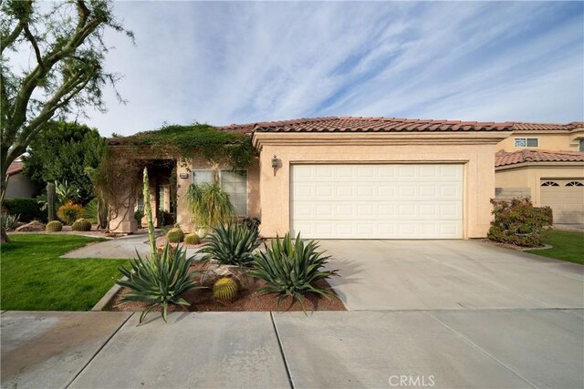 mediterranean / spanish home featuring a garage