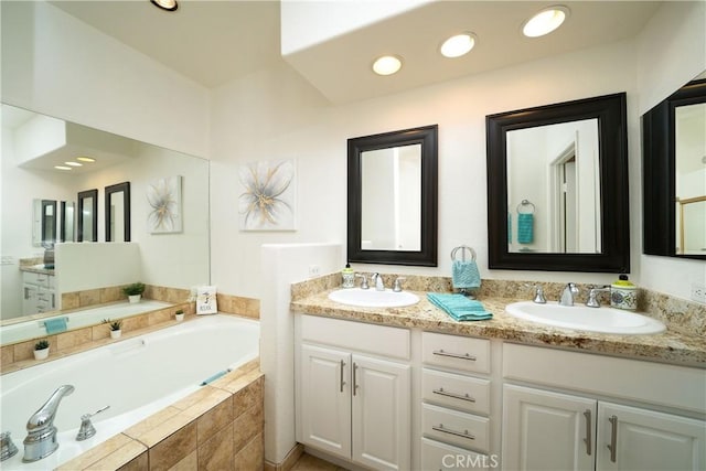 bathroom featuring vanity and a relaxing tiled tub