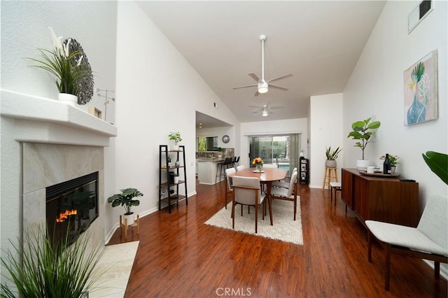 dining room with high vaulted ceiling, dark hardwood / wood-style floors, and ceiling fan