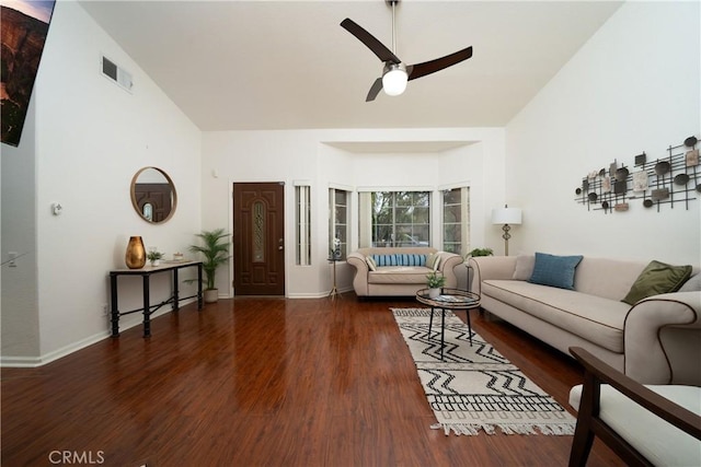 living room featuring ceiling fan, dark hardwood / wood-style flooring, and a high ceiling