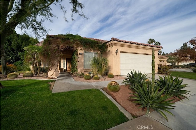 view of front of home with a front yard and a garage