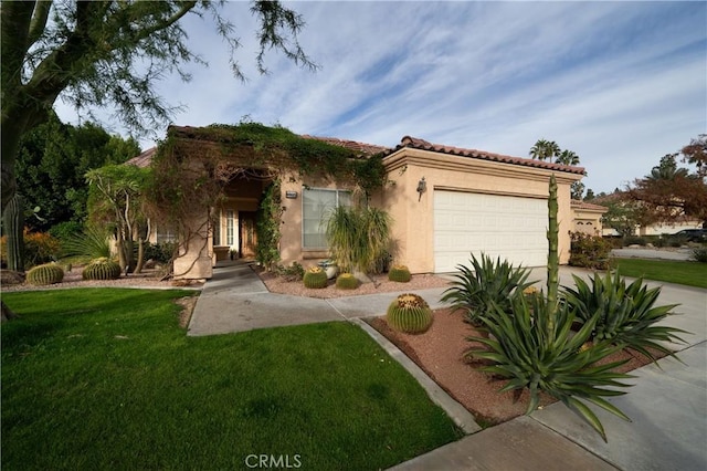 view of front facade with a garage and a front lawn