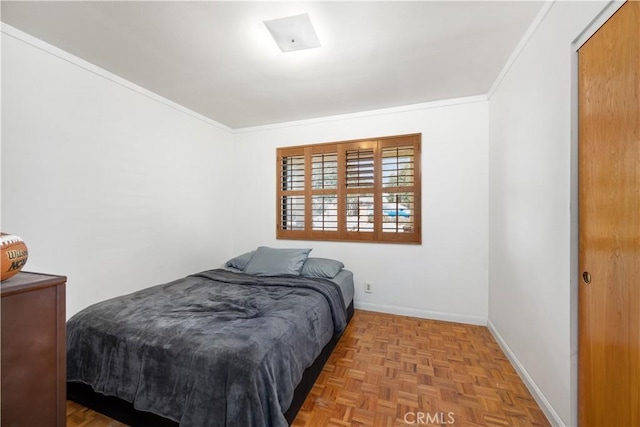 bedroom with crown molding and light parquet floors