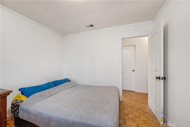 bedroom with crown molding and parquet floors