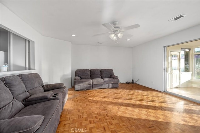 living room with ceiling fan and light parquet floors