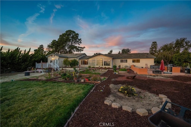 view of front of home featuring a patio area and a lawn