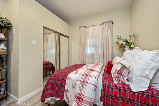 bedroom with hardwood / wood-style flooring and a closet