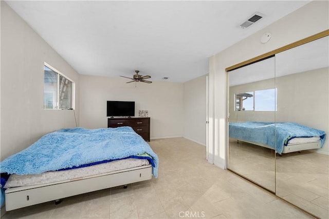 bedroom with ceiling fan and a closet