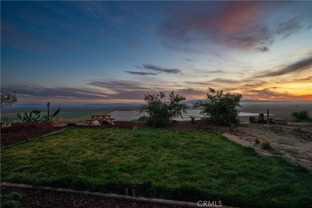 yard at dusk with a water view