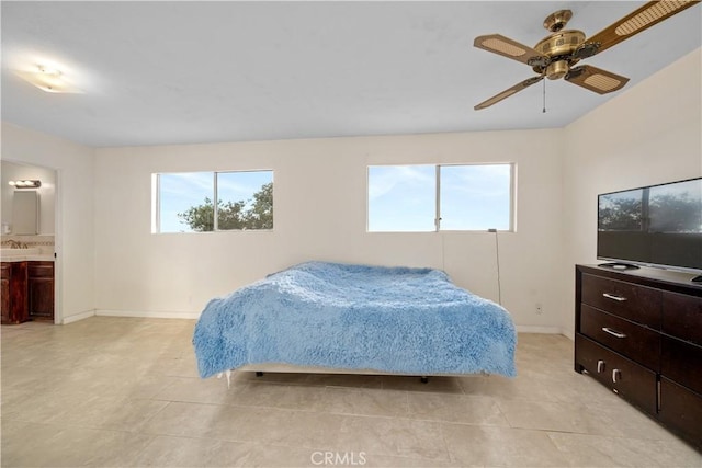 bedroom with light tile patterned flooring, connected bathroom, multiple windows, and ceiling fan