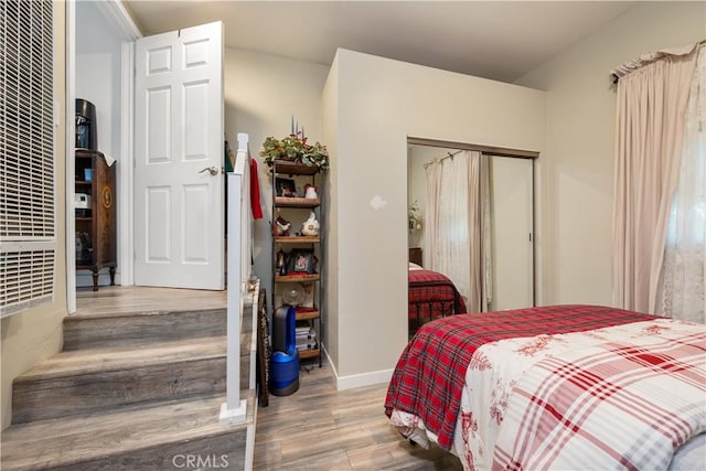 bedroom with hardwood / wood-style flooring and a closet