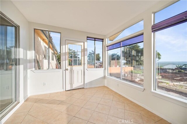 unfurnished sunroom featuring a wealth of natural light