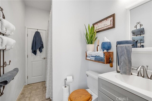 bathroom featuring tile patterned flooring, vanity, and toilet