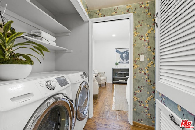 laundry room featuring independent washer and dryer and hardwood / wood-style flooring