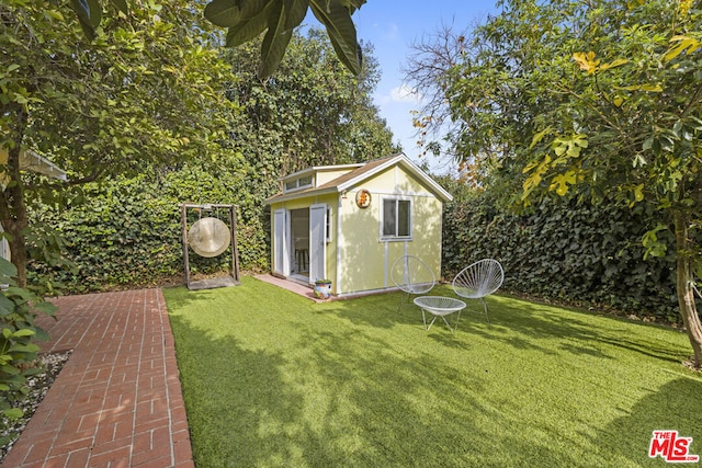 view of outdoor structure featuring a lawn