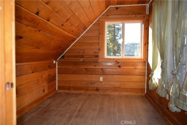 additional living space featuring wood-type flooring, lofted ceiling, wood walls, and wood ceiling