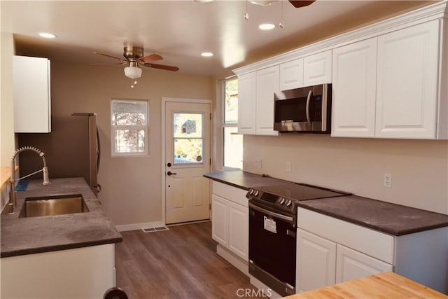 kitchen featuring electric range and white cabinets