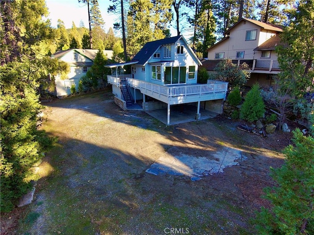 rear view of property featuring a deck