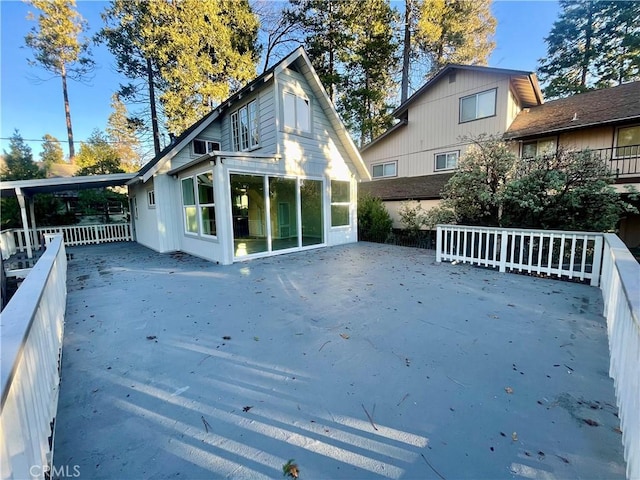 rear view of house featuring a sunroom