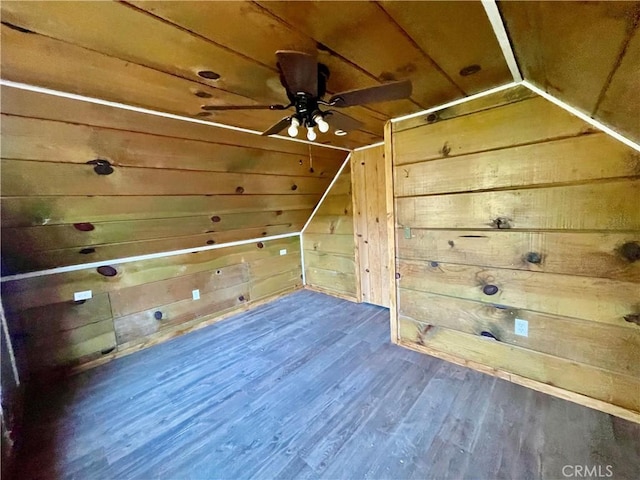 additional living space featuring dark wood-type flooring, vaulted ceiling, wood ceiling, and wooden walls