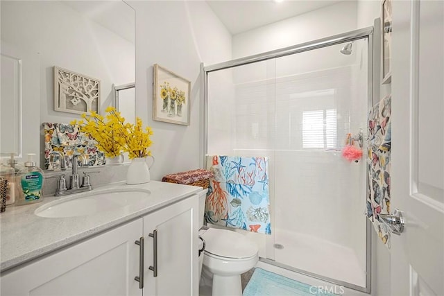 bathroom with vanity, toilet, and walk in shower