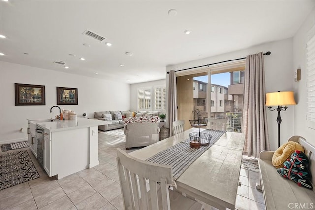 dining space with light tile patterned floors and sink