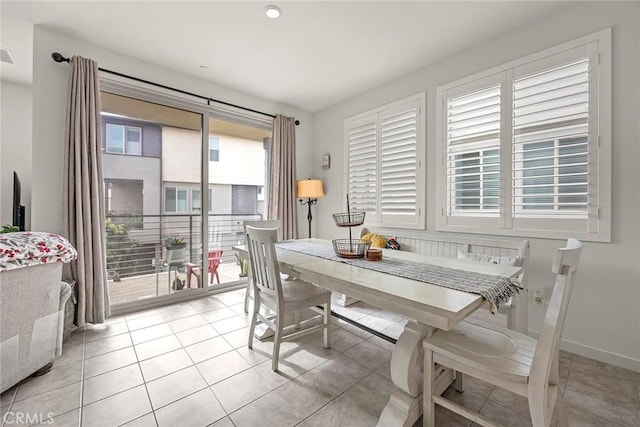 dining area with a wealth of natural light and light tile patterned floors