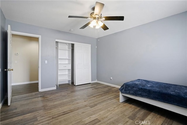 bedroom featuring ceiling fan, a closet, and wood-type flooring