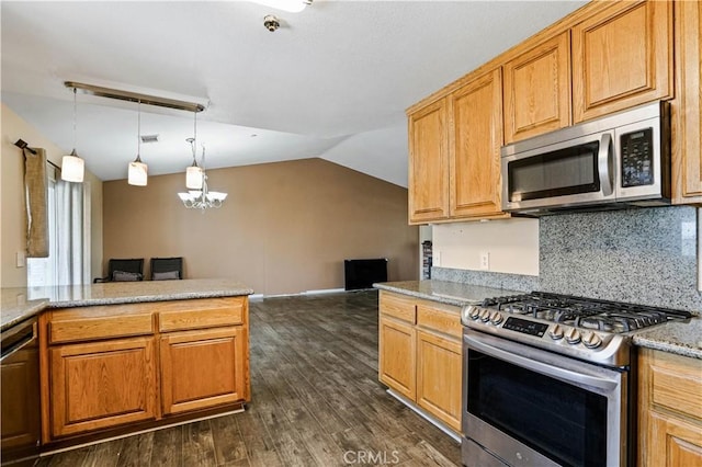 kitchen with stainless steel appliances, dark hardwood / wood-style flooring, a chandelier, vaulted ceiling, and decorative light fixtures