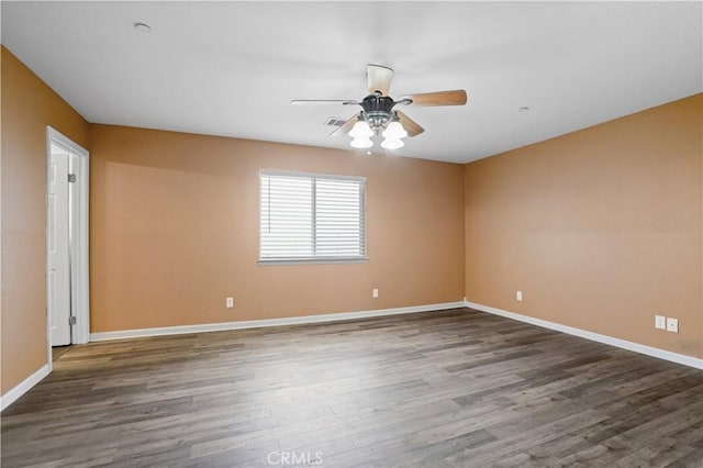 spare room featuring dark hardwood / wood-style floors and ceiling fan