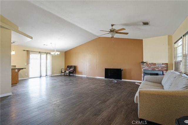 living room with ceiling fan with notable chandelier, dark hardwood / wood-style flooring, and a healthy amount of sunlight