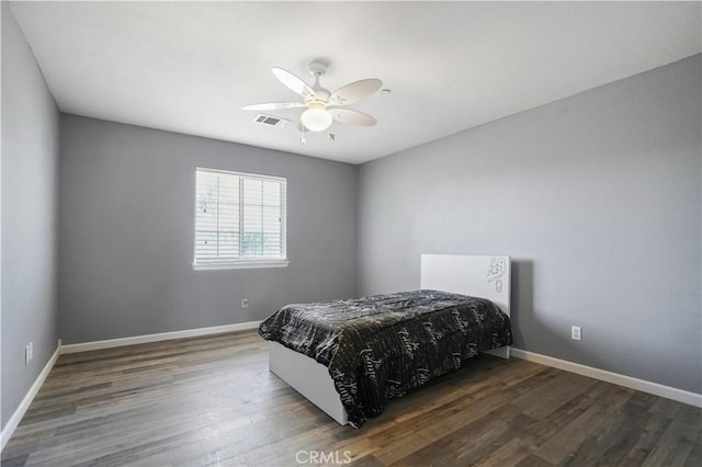 bedroom with ceiling fan and dark wood-type flooring