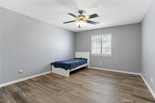 unfurnished bedroom featuring ceiling fan and hardwood / wood-style flooring