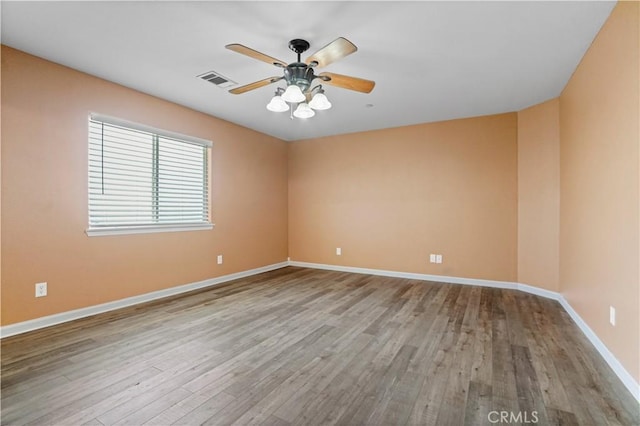 spare room with ceiling fan and hardwood / wood-style floors