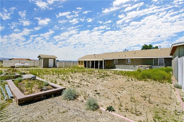 view of yard with a sunroom and a storage shed