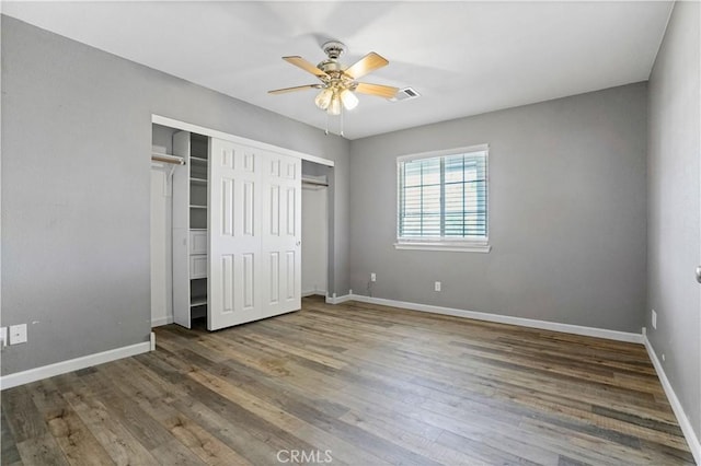 unfurnished bedroom with dark hardwood / wood-style flooring and ceiling fan