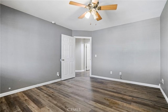 unfurnished room featuring ceiling fan and dark wood-type flooring