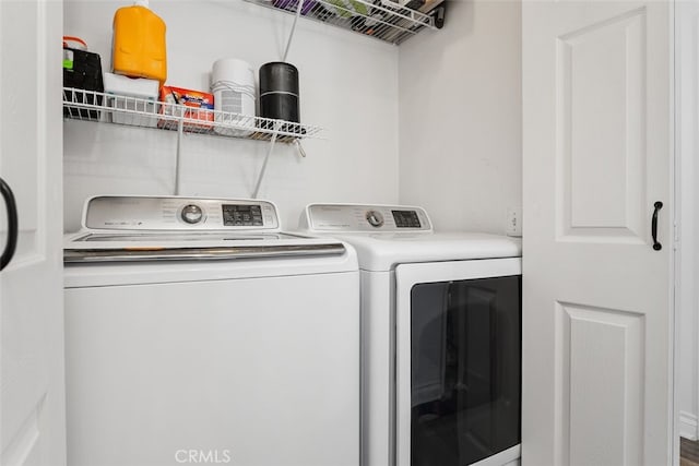 clothes washing area with washing machine and dryer