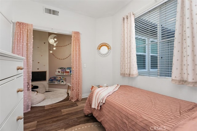 bedroom with dark hardwood / wood-style flooring