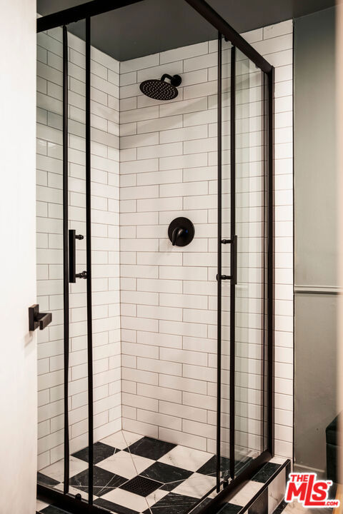 bathroom with a shower with shower door