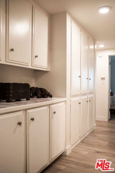 kitchen featuring white cabinets and light wood-type flooring