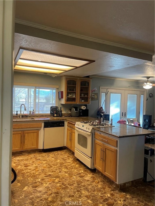 kitchen featuring kitchen peninsula, white appliances, and ornamental molding