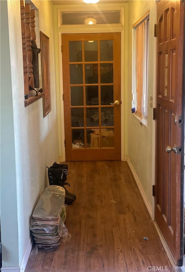 corridor with hardwood / wood-style floors