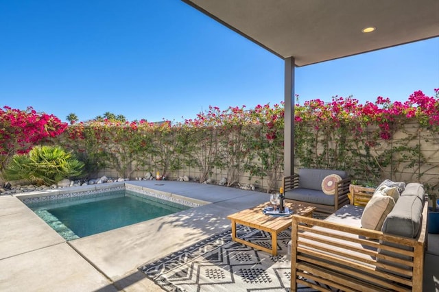 view of swimming pool with an outdoor living space and a patio area