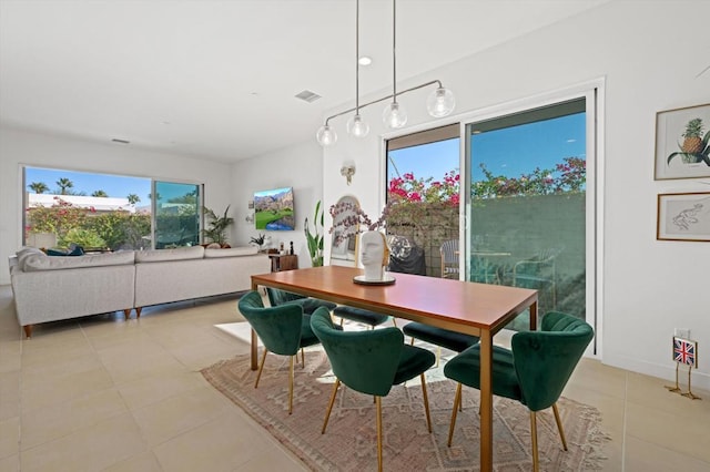 dining room featuring light tile patterned floors and a wealth of natural light