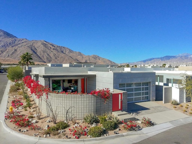 view of front facade with a mountain view and a garage