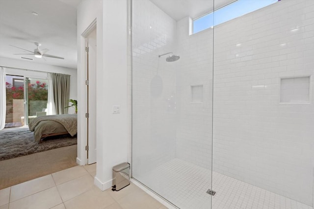 bathroom with tile patterned floors, ceiling fan, a shower with door, and a healthy amount of sunlight