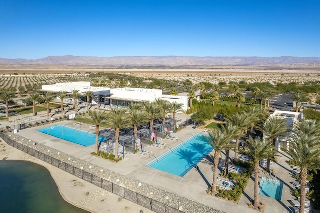 birds eye view of property with a mountain view