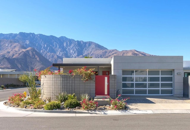 view of front of property featuring a mountain view and a garage