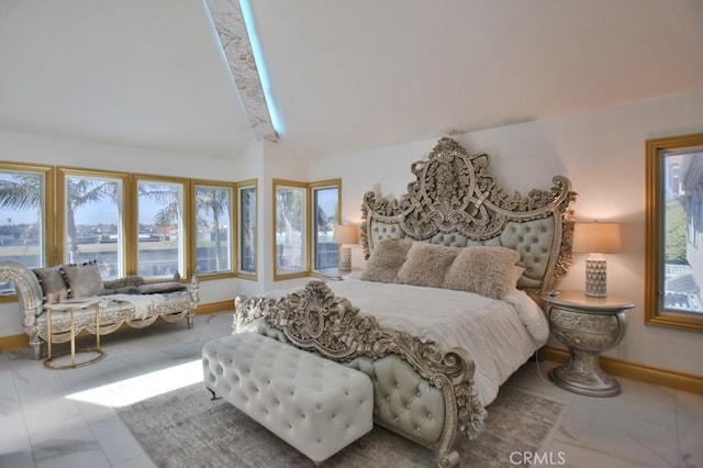 bedroom with multiple windows and vaulted ceiling with beams